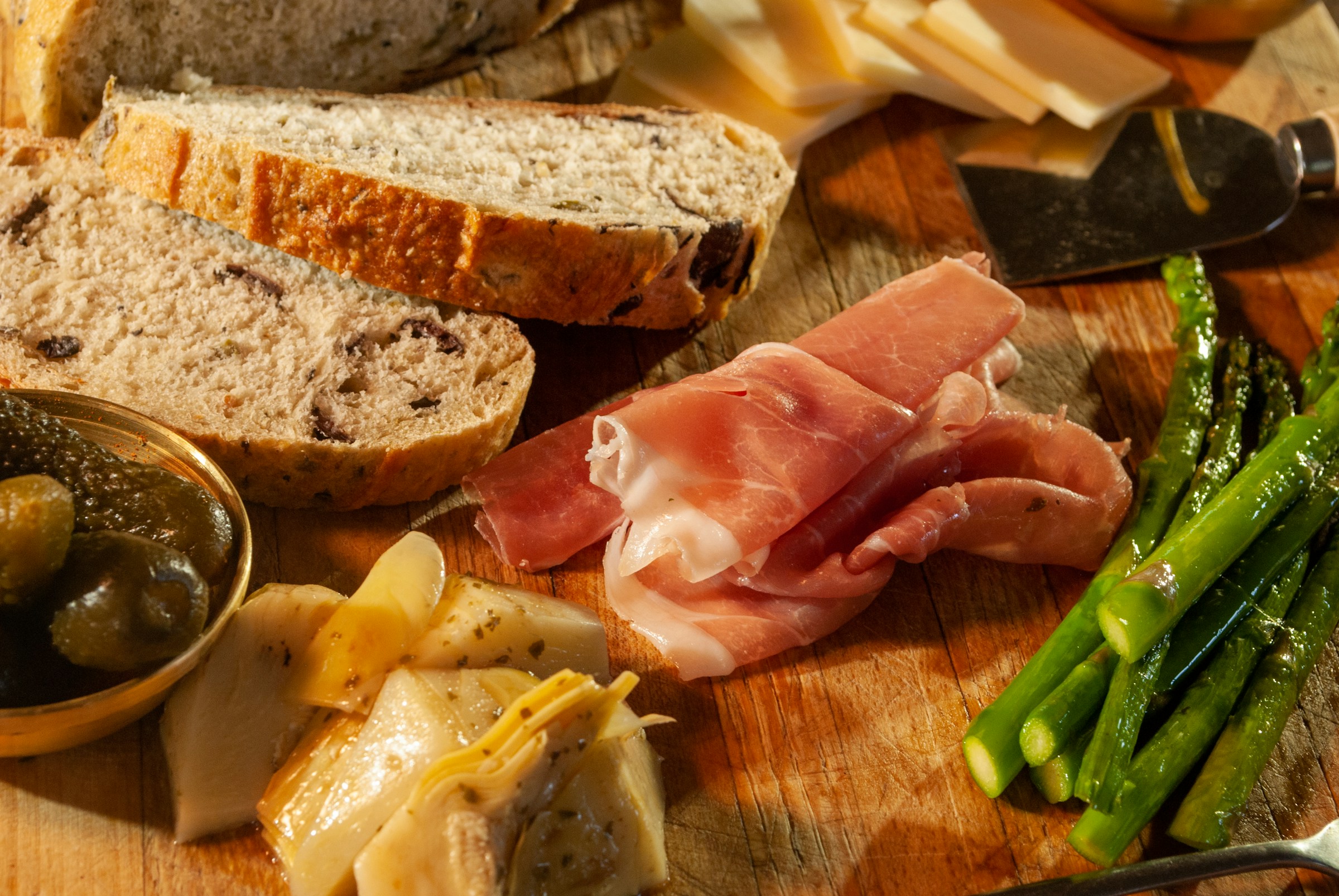Gourmet antipasto platter with cured meats, cheese, olives and artisan bread
