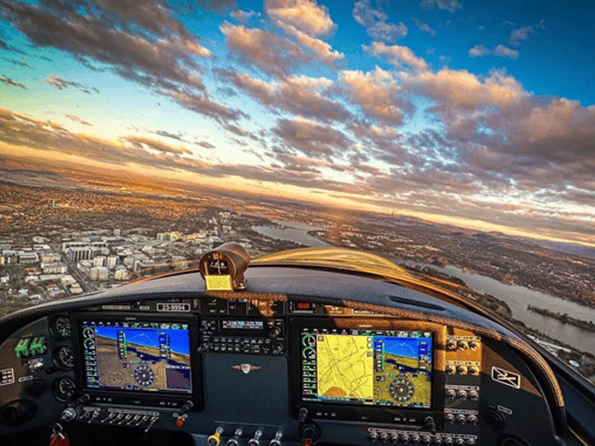 Cockpit view over Canberra and Lake Burley Griffin at sunset