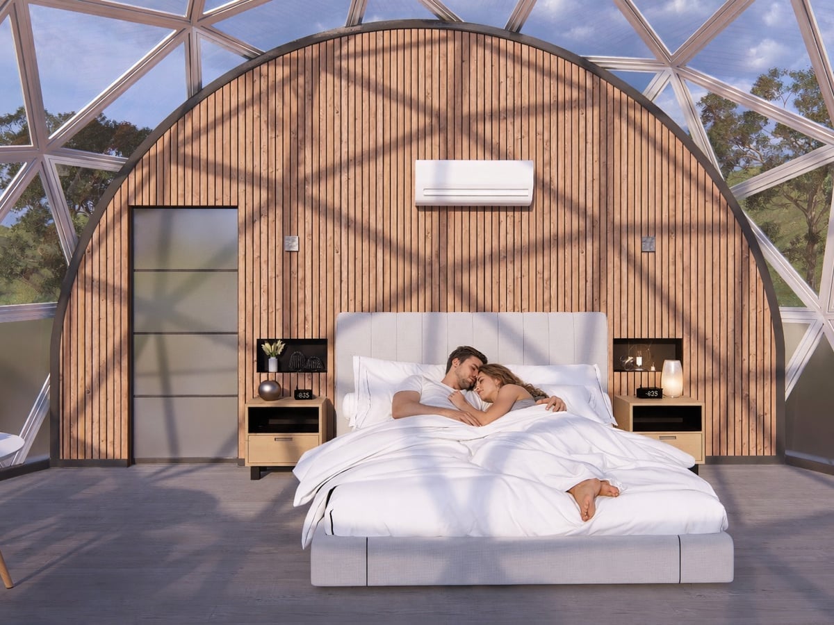 Couple relaxing in the Songlines Suite geodesic dome bedroom